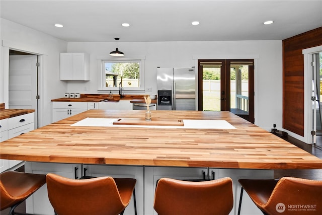 1517 Pioneer Hwy, Silvana, WA 98287 - kitchen featuring wooden counters, stainless steel fridge, recessed lighting, white cabinets, and french doors