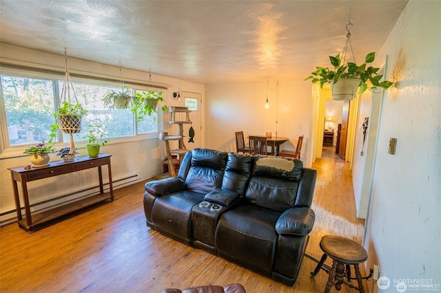 living area featuring wood finished floors and a baseboard radiator