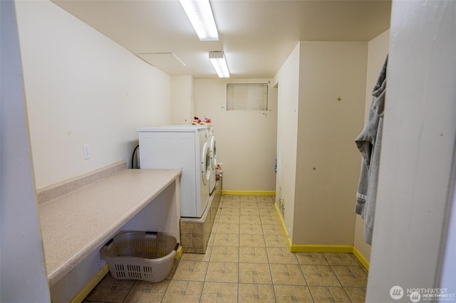 laundry area with independent washer and dryer, laundry area, and baseboards