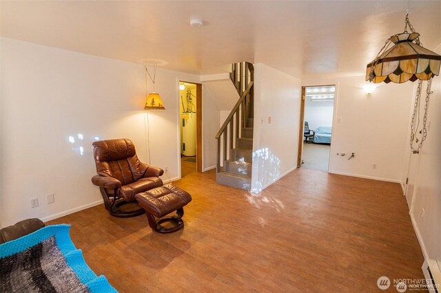 unfurnished room featuring baseboards, stairs, and wood finished floors