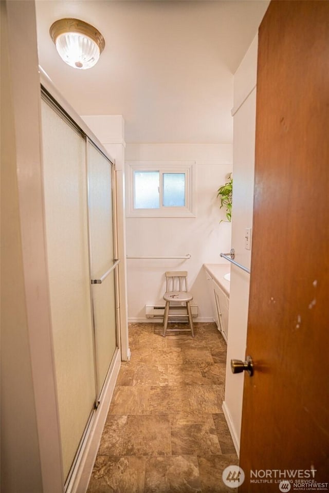 bathroom featuring a stall shower and stone finish floor