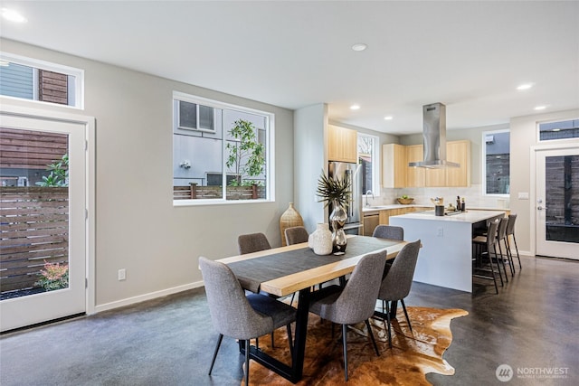 dining room featuring recessed lighting, baseboards, and concrete floors
