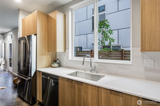kitchen with a sink, light countertops, decorative backsplash, and stainless steel appliances