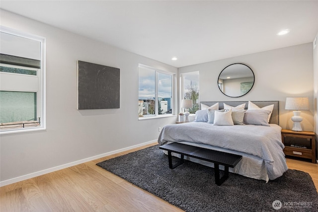 bedroom with recessed lighting, baseboards, and light wood finished floors