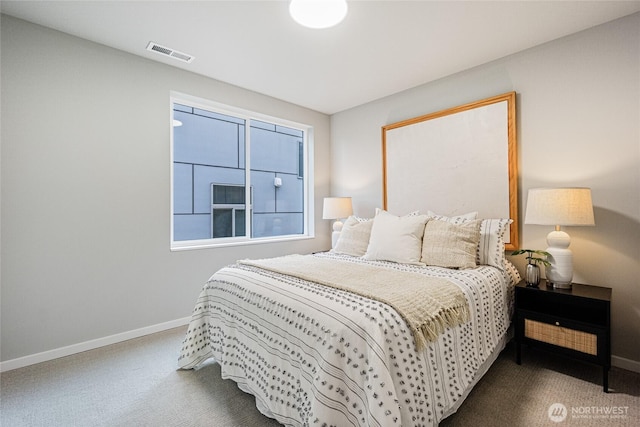 carpeted bedroom with baseboards and visible vents