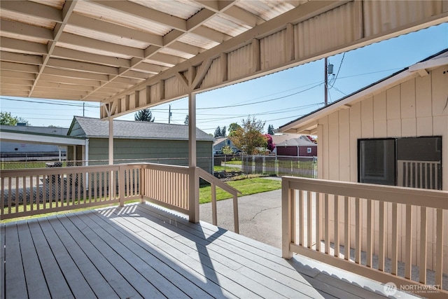 wooden terrace featuring a fenced backyard and a yard