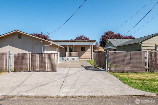 ranch-style house featuring fence, a porch, and driveway