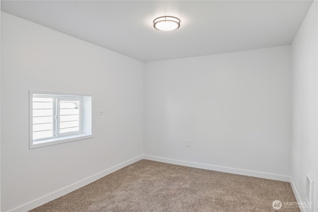 carpeted spare room with baseboards
