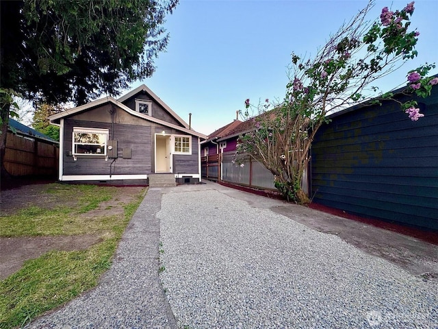 view of front facade featuring fence and crawl space