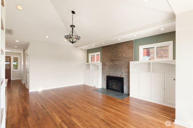 unfurnished living room featuring recessed lighting, a healthy amount of sunlight, and wood finished floors
