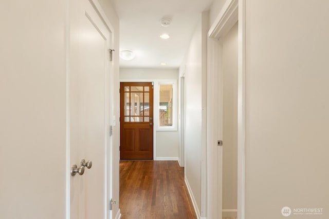 hallway featuring recessed lighting, baseboards, and dark wood finished floors