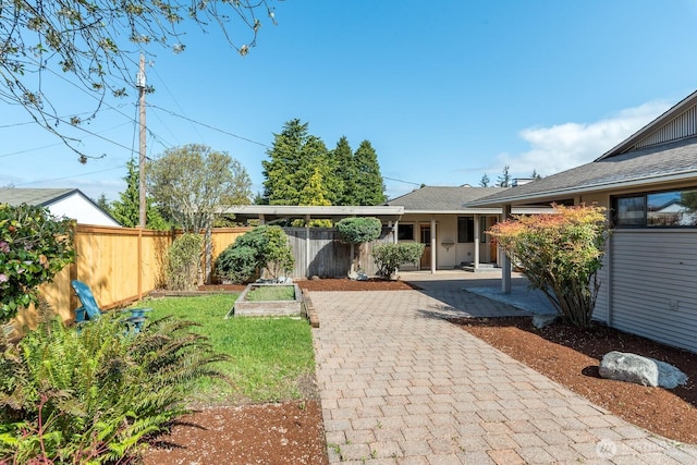 exterior space featuring fence, a garden, and a patio area