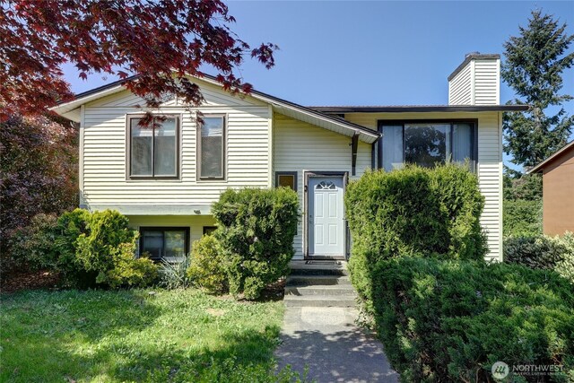 1917 E 60th St, Tacoma, WA 98404 - view of front of property with a chimney and a front yard