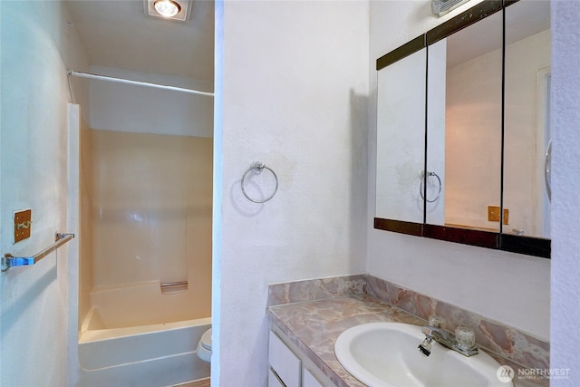 1917 E 60th St, Tacoma, WA 98404 - bathroom with vanity, washtub / shower combination, and toilet