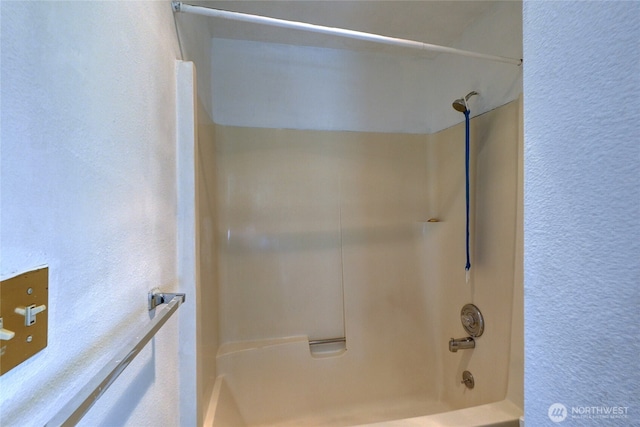 1917 E 60th St, Tacoma, WA 98404 - bathroom featuring shower / bath combination and a textured wall