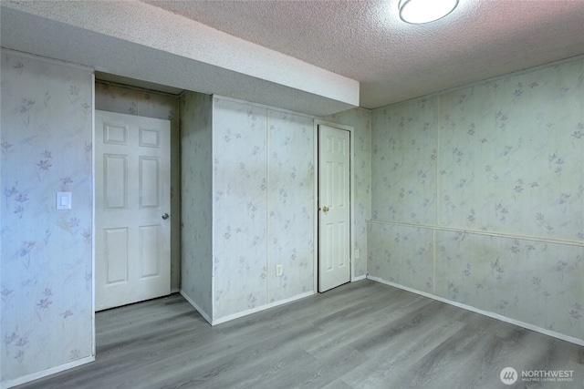 1917 E 60th St, Tacoma, WA 98404 - interior space with baseboards, a textured ceiling, and wood finished floors