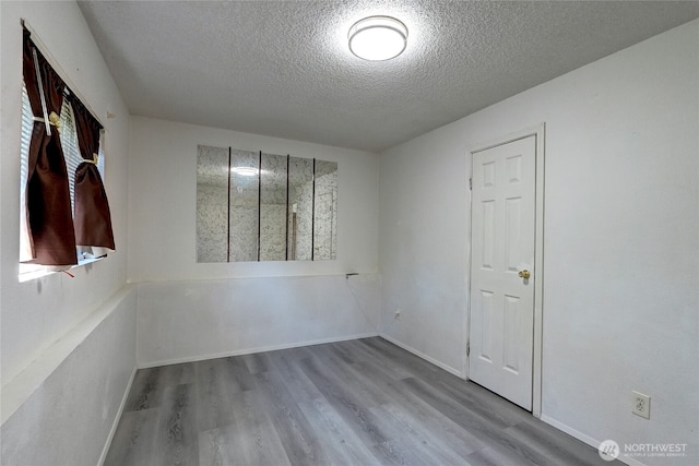 1917 E 60th St, Tacoma, WA 98404 - empty room featuring baseboards, a textured ceiling, and wood finished floors