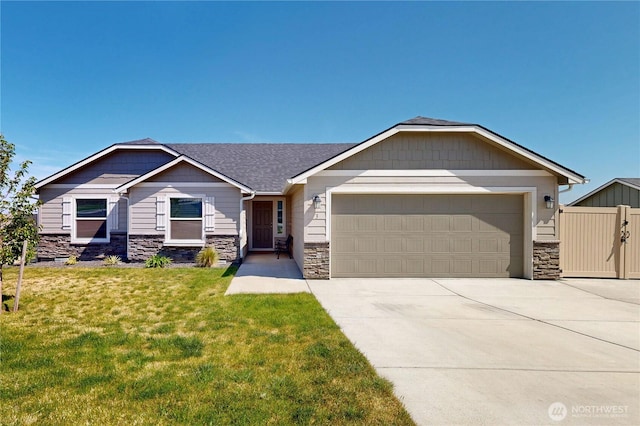 3 Gregory St, Milton-Freewater, OR 97862 - view of front of house featuring stone siding, an attached garage, concrete driveway, and a shingled roof