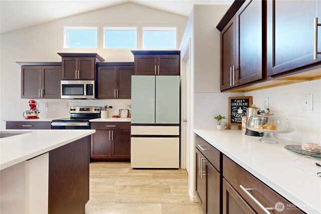 3 Gregory St, Milton-Freewater, OR 97862 - kitchen featuring stainless steel appliances, light countertops, light wood-style flooring, lofted ceiling, and dark brown cabinetry