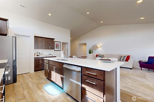 3 Gregory St, Milton-Freewater, OR 97862 - kitchen featuring stainless steel appliances, a sink, light countertops, dark brown cabinetry, and vaulted ceiling