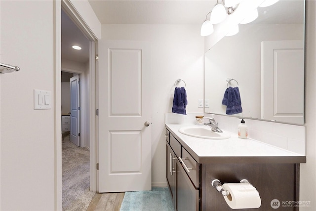 3 Gregory St, Milton-Freewater, OR 97862 - bathroom with vanity, decorative backsplash, and wood finished floors