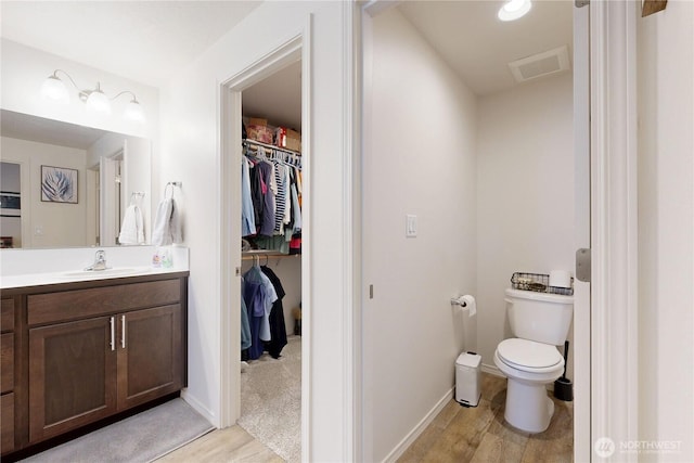 3 Gregory St, Milton-Freewater, OR 97862 - bathroom featuring a walk in closet, wood finished floors, and toilet