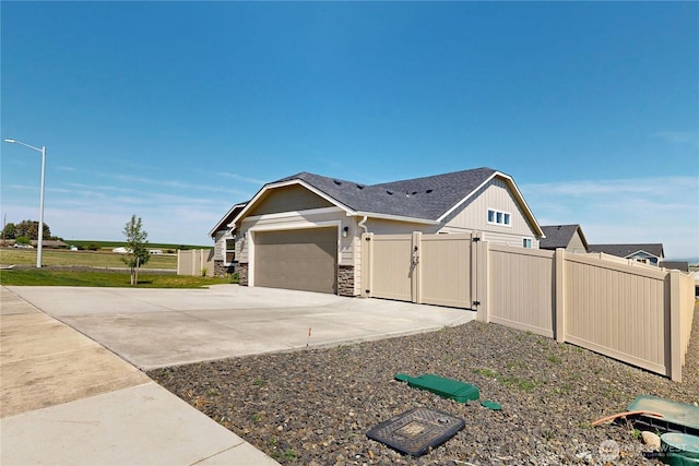 3 Gregory St, Milton-Freewater, OR 97862 - view of property exterior featuring fence, concrete driveway, a garage, and a gate