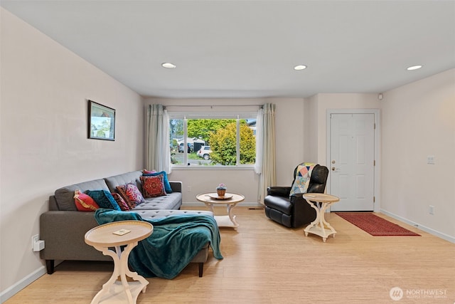 living room featuring wood finished floors, baseboards, and recessed lighting