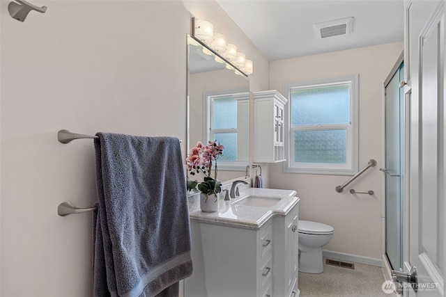 bathroom with toilet, vanity, and baseboards