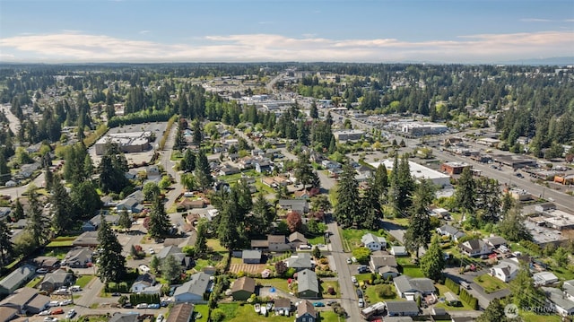 aerial view of property and surrounding area featuring nearby suburban area