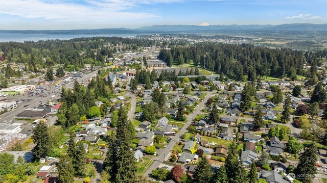 aerial view of property's location featuring mountains and a forest