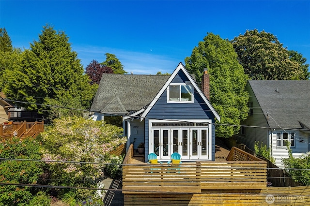 rear view of property with french doors and a chimney