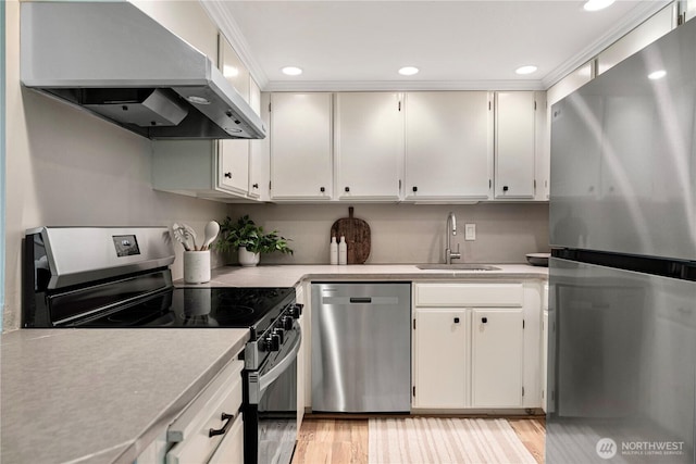 912 3rd Ave W Unit 303, Seattle, WA 98119 - kitchen featuring light countertops, appliances with stainless steel finishes, range hood, and a sink