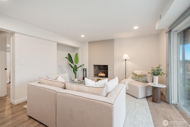 6409 NW 202nd Cir, Ridgefield, WA 98642 - living area with light wood-style floors, a fireplace, recessed lighting, and baseboards