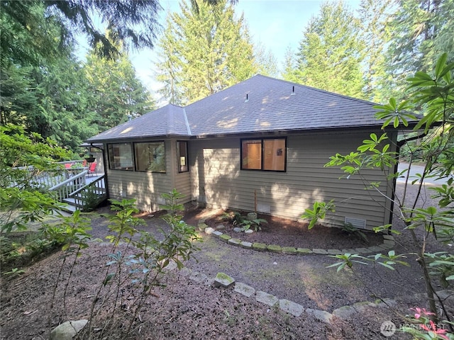 rear view of house with a shingled roof