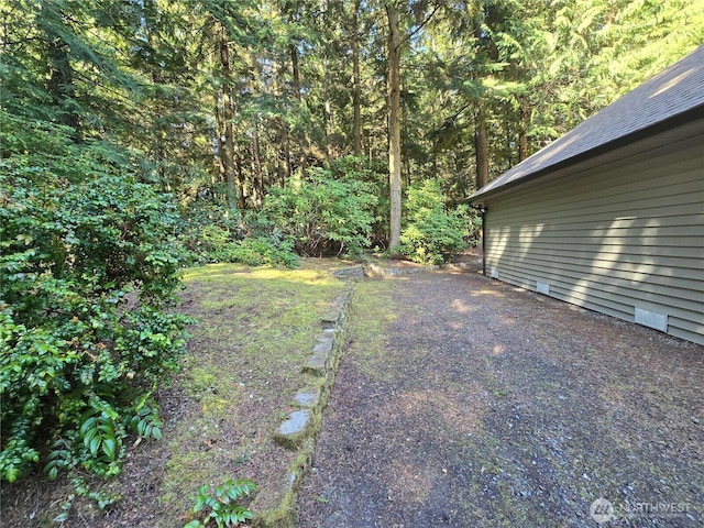 view of yard featuring a view of trees