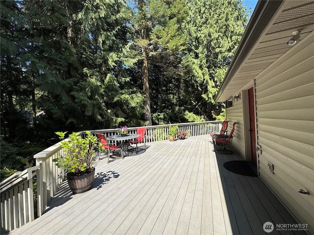 wooden terrace featuring outdoor dining area