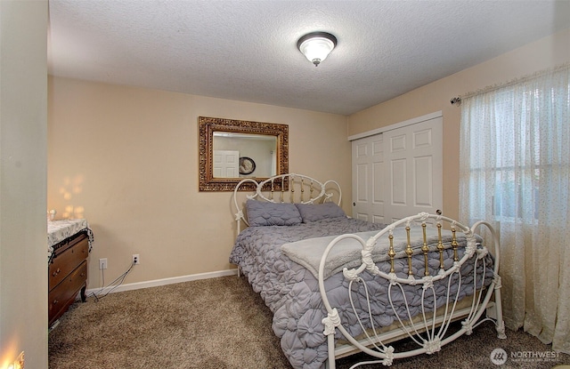 carpeted bedroom with baseboards, a closet, and a textured ceiling
