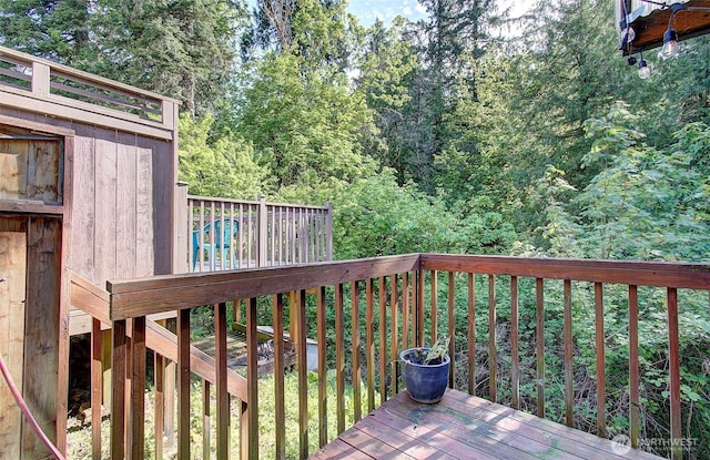 wooden deck featuring a forest view