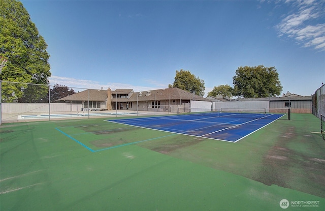 view of sport court with fence