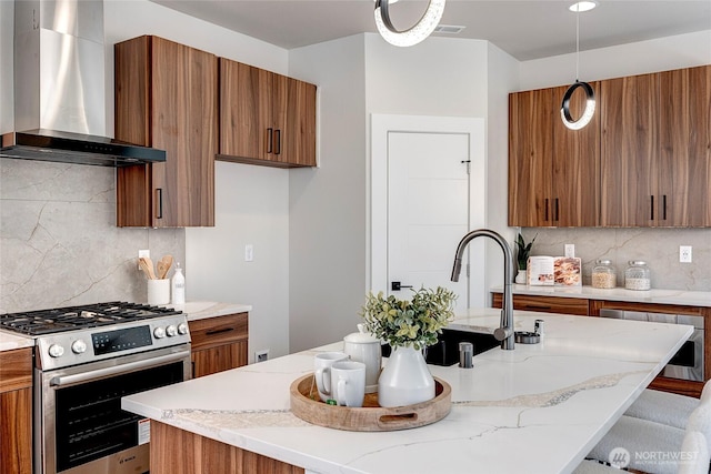 21403 39th Dr SE Unit B, Bothell, WA 98021 - kitchen with stainless steel gas range oven, wall chimney exhaust hood, brown cabinetry, and tasteful backsplash