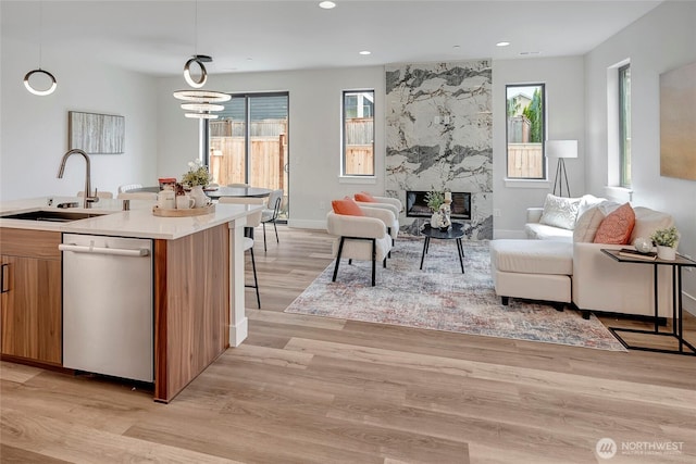 21403 39th Dr SE Unit B, Bothell, WA 98021 - living room featuring light wood-type flooring, a premium fireplace, recessed lighting, baseboards, and a chandelier