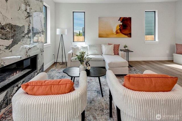 21403 39th Dr SE Unit B, Bothell, WA 98021 - living room featuring wood finished floors, baseboards, and a high end fireplace