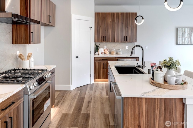 21403 39th Dr SE Unit B, Bothell, WA 98021 - kitchen with stainless steel appliances, wall chimney exhaust hood, a sink, decorative backsplash, and modern cabinets