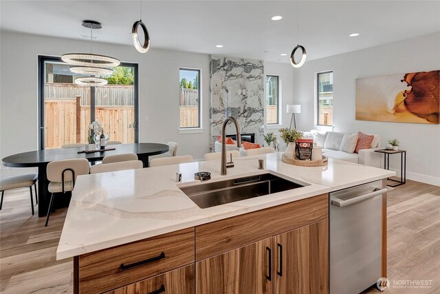 21403 39th Dr SE Unit B, Bothell, WA 98021 - kitchen featuring a sink, brown cabinets, stainless steel dishwasher, plenty of natural light, and recessed lighting
