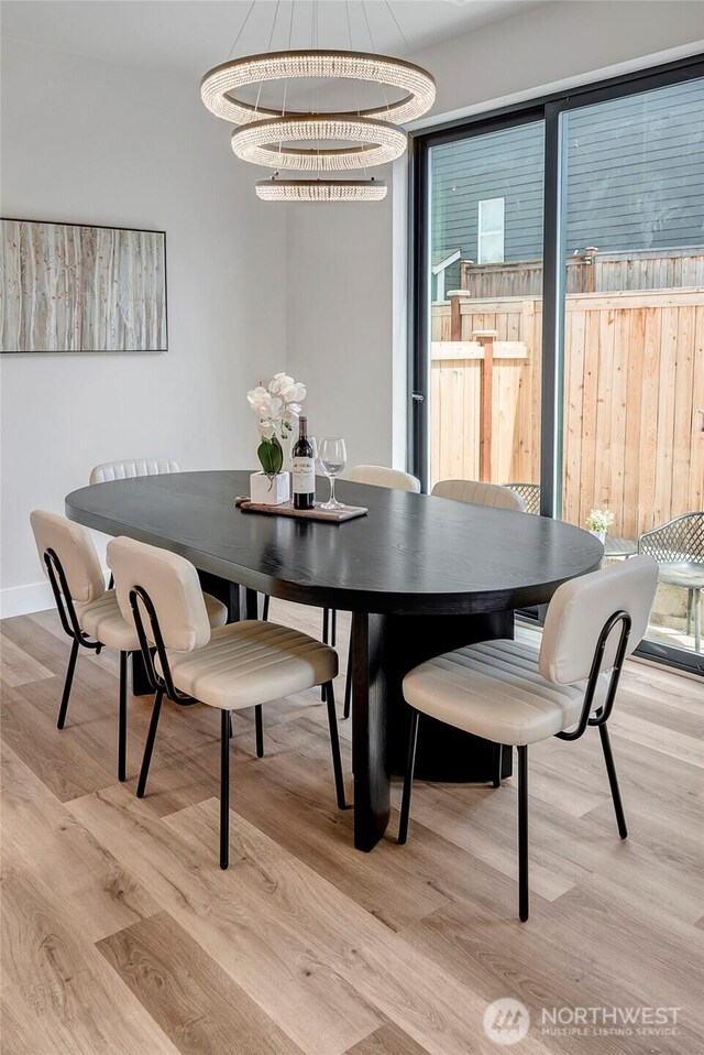 21403 39th Dr SE Unit B, Bothell, WA 98021 - dining space with light wood-style flooring, baseboards, and a chandelier