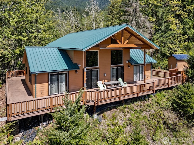 0 Boyd Rd, White Pass, WA 98377 - back of property with a standing seam roof, a wooden deck, metal roof, and a wooded view