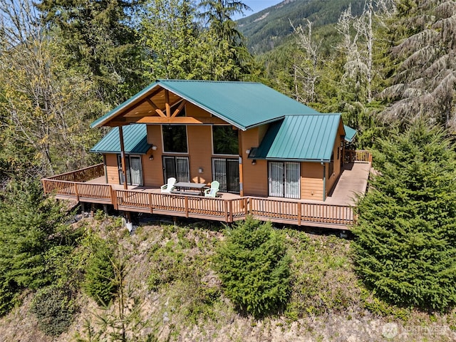 0 Boyd Rd, White Pass, WA 98377 - rear view of house with a view of trees, a deck with mountain view, and metal roof