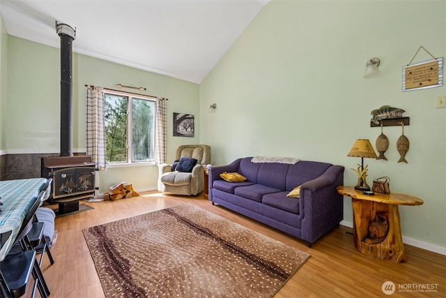 0 Boyd Rd, White Pass, WA 98377 - living area with baseboards, a wood stove, wood finished floors, and high vaulted ceiling