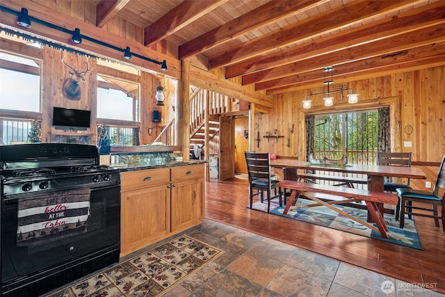 0 Boyd Rd, White Pass, WA 98377 - kitchen featuring dark wood finished floors, wood walls, beam ceiling, wooden ceiling, and black gas range oven